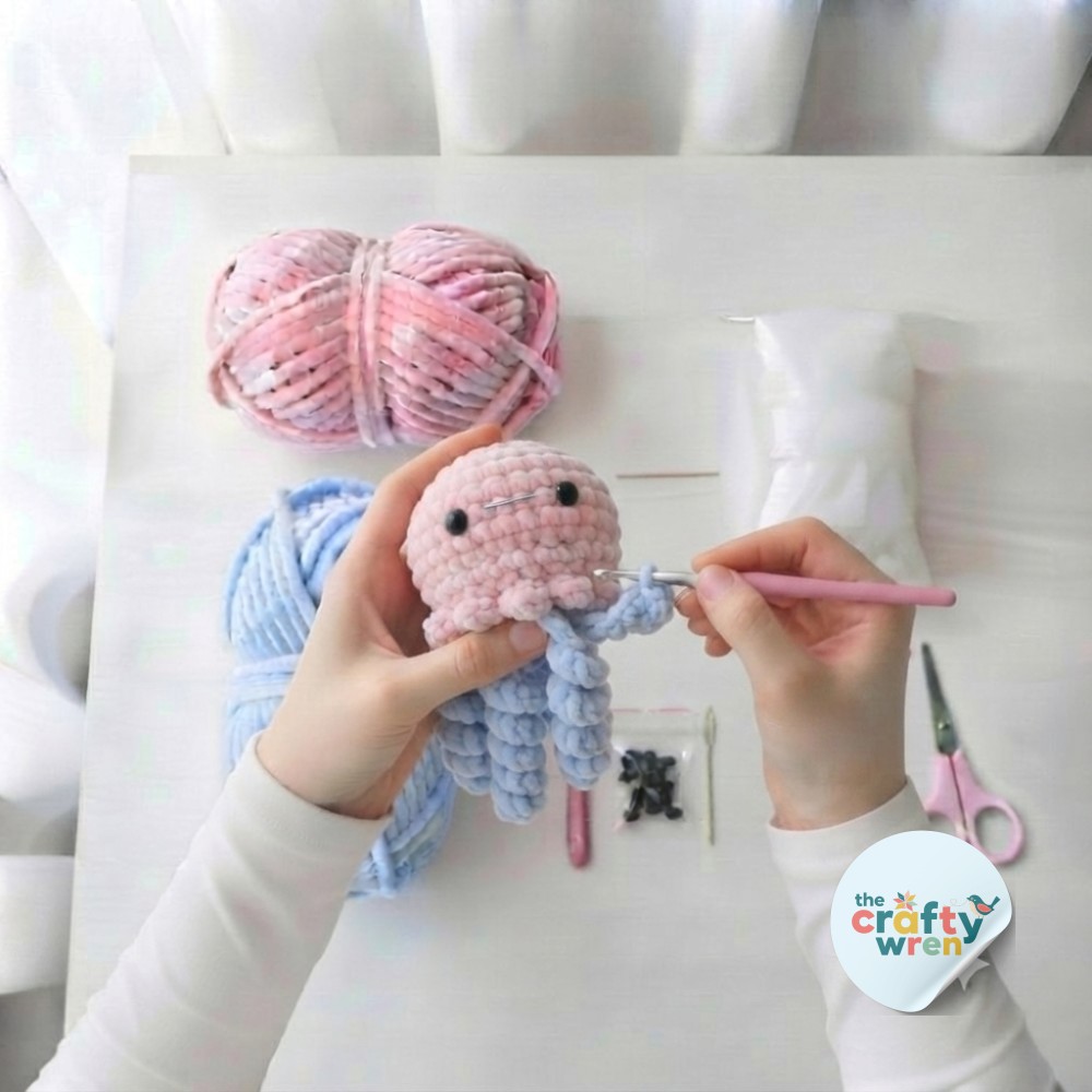 Three finished curling blue tentacles beside five short stubs mid-progress on this amigurumi octopus crochet pattern