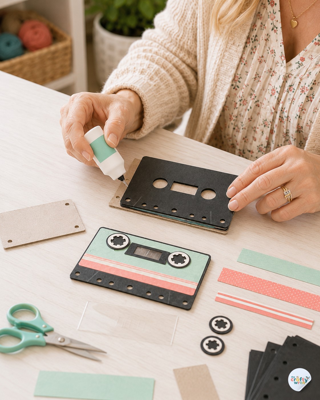 Applying glue to the cassette cover panel while assembling a cassette tape flipbook gift