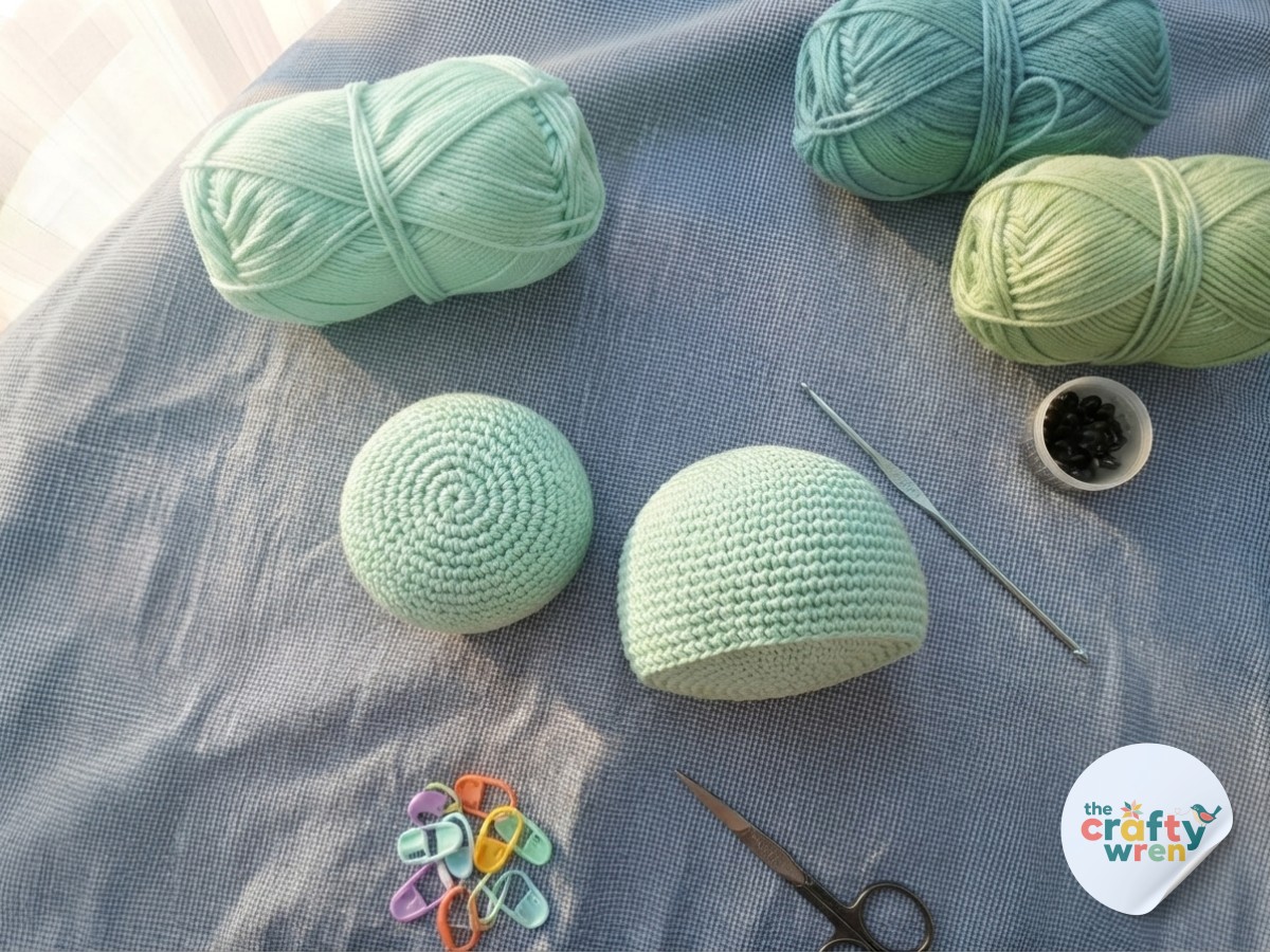 Completed mint head and dome body base for the crochet sea turtle plushie resting side by side