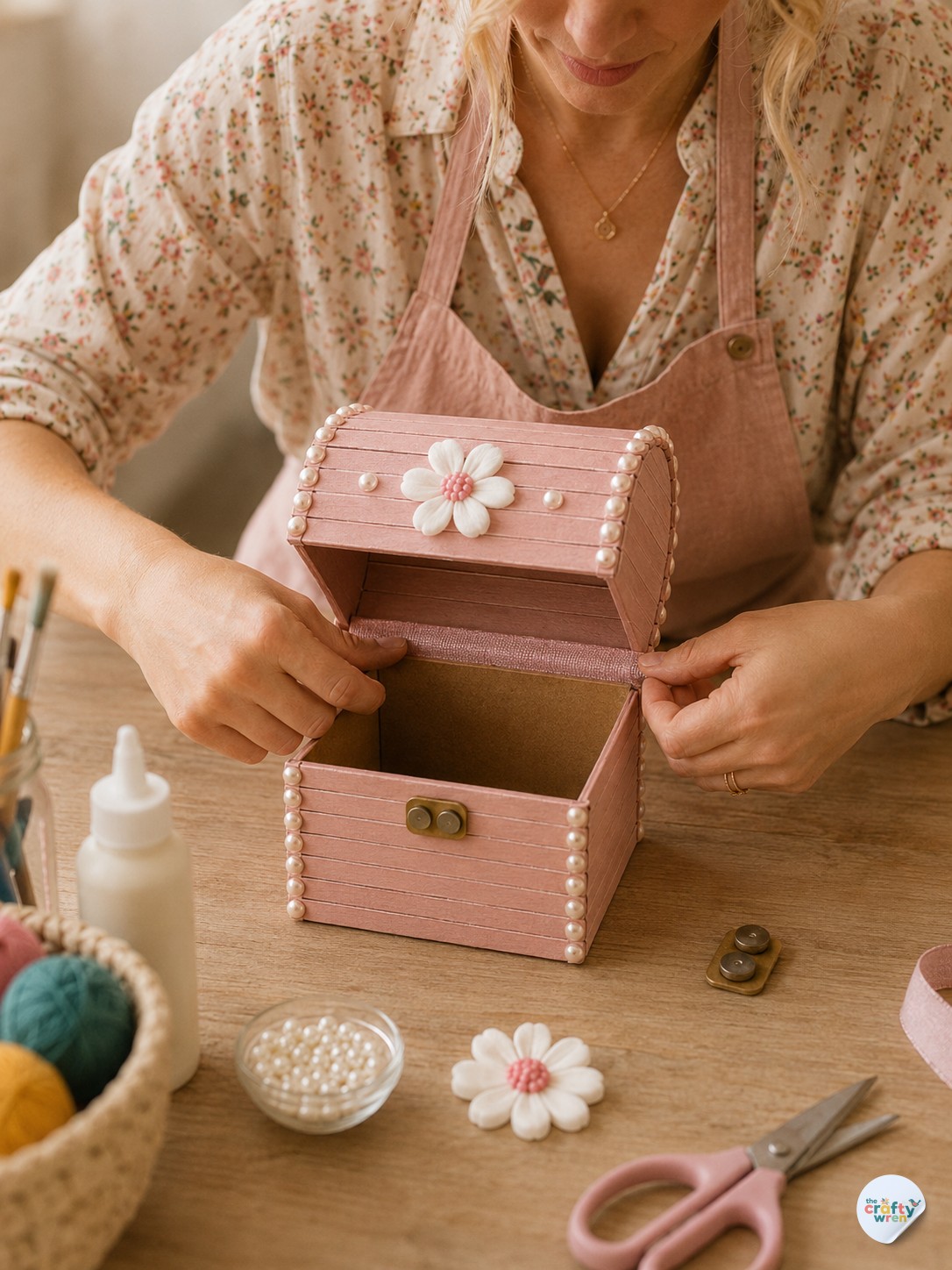 Opening the finished popsicle stick treasure box to show its lined interior and ribbon hinge.
