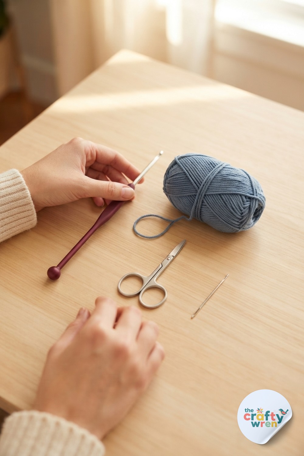 Tunisian hook and yarn laid out on wooden table