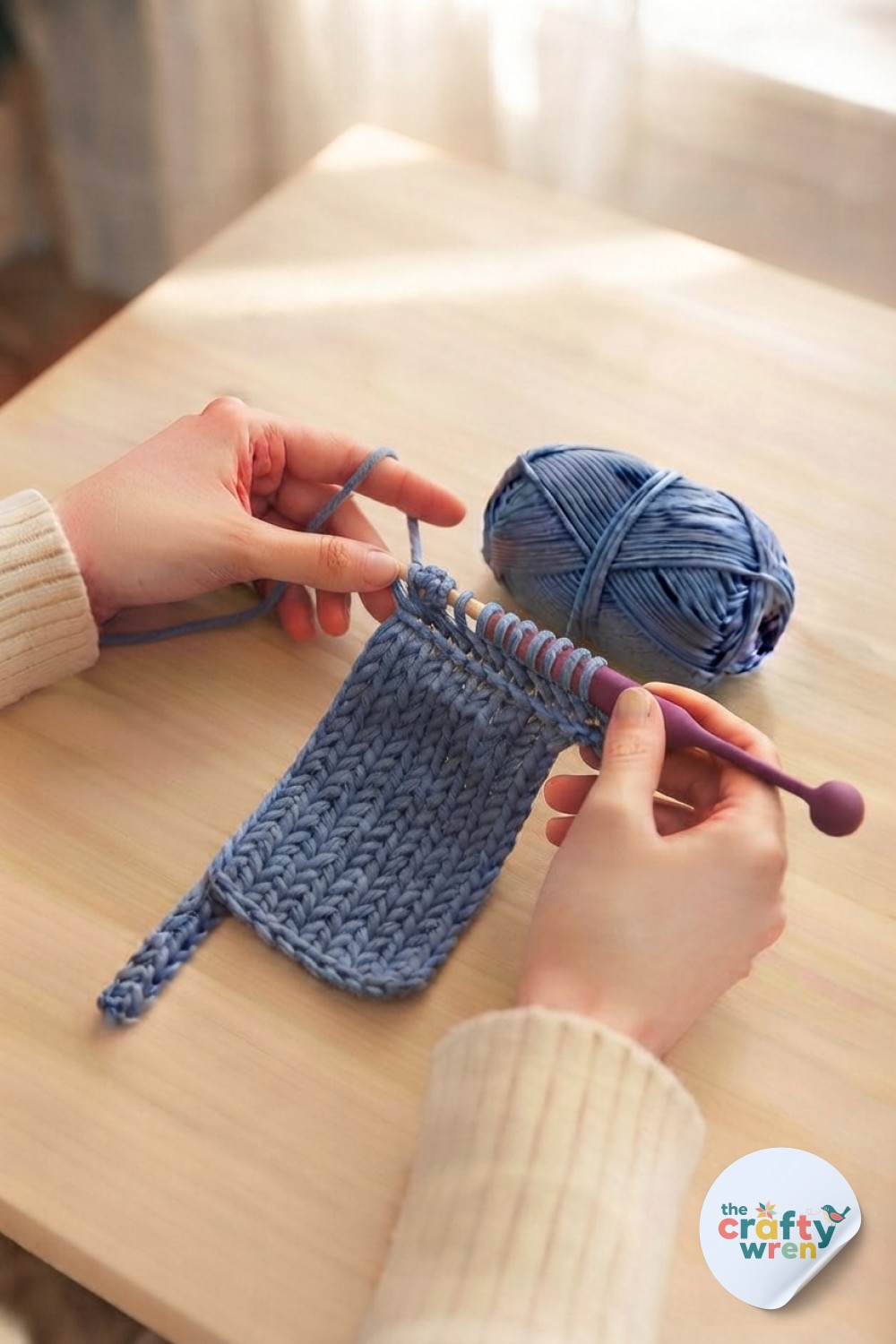 Hands making bumpy purl texture on Tunisian swatch