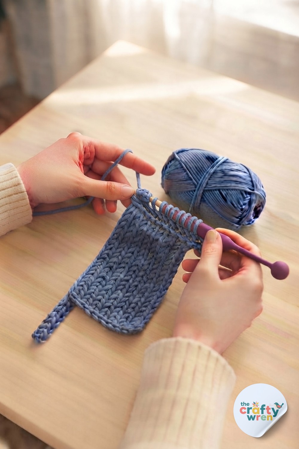 Close-up of hands securing the swatch's edge stitch